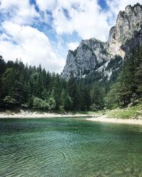 Scenic view of mountains and river against sky