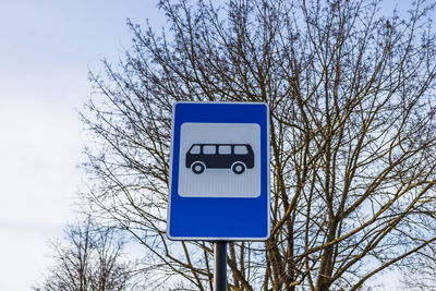 Blue and white bus stop sign in europe on the sky background