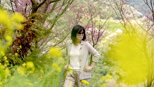 Woman standing by plants