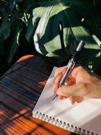 Close-up of hand holding pen