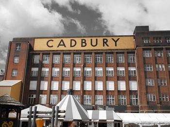 Low angle view of building against cloudy sky