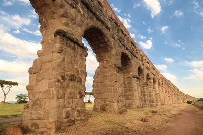 Low angle view of ancient roman aqueduct against sky