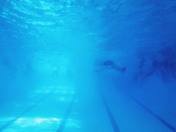 Low angle view of people swimming in pool