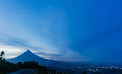 Scenic view of mountains against blue sky