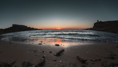 Scenic view of sea against clear sky during sunset