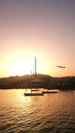 View of boats in sea at sunset