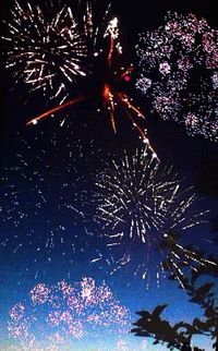 Low angle view of firework display at night
