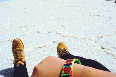 Low section of person relaxing on salt flat