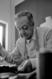 Mid adult man sitting on table