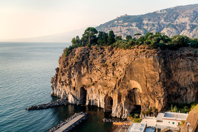 Scenic view of sea and mountain against sky