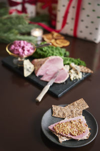 Christmas ham and presents on table