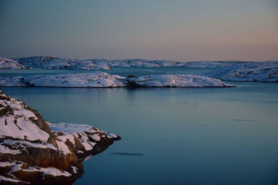 Scenic view of frozen lake against sky during winter