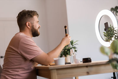 Side view of man working at home