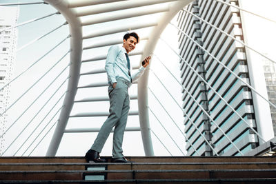 Low angle view of man standing on staircase