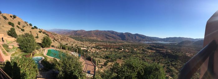 Scenic view of mountains against clear blue sky