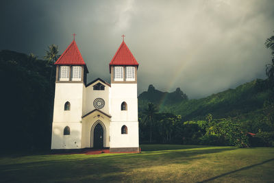 Church by building against sky