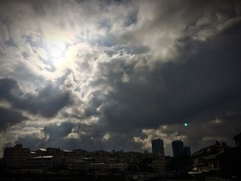 Low angle view of buildings against cloudy sky