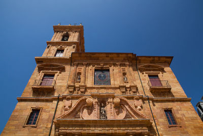 Low angle view of building against clear blue sky