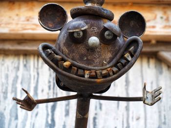 Close-up of rusty chain hanging on wood