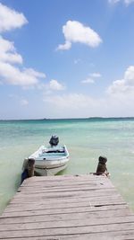 View of jetty in sea against sky