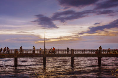 Pier on sea at sunset