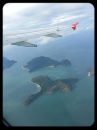 Cropped image of airplane flying over landscape