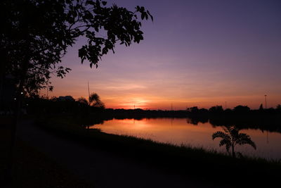 Scenic view of lake against romantic sky at sunset