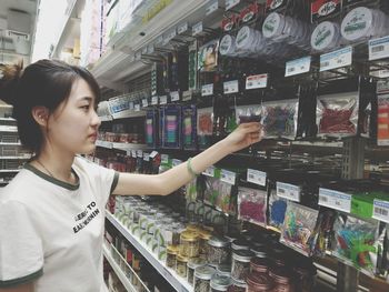 Young woman standing at store