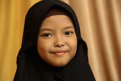 Close-up portrait of smiling girl in hijab