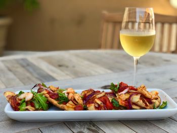 Close-up of shrimp and wine served on table