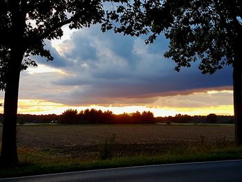 Scenic view of field against sky during sunset