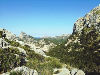 Scenic view of mountains against clear blue sky