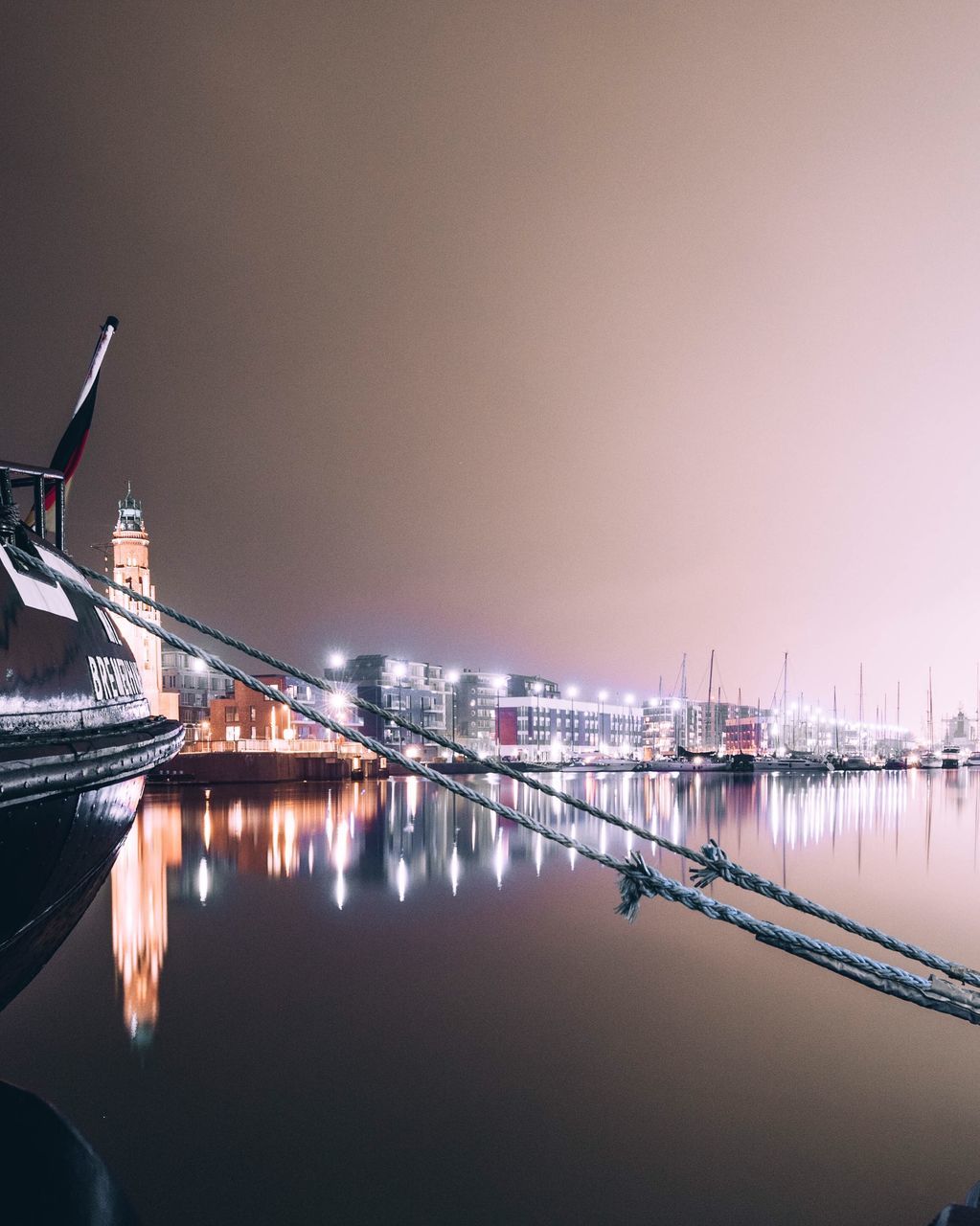 SAILBOATS IN SEA AGAINST SKY AT NIGHT