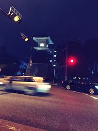 Illuminated city street at night