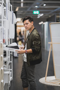 Portrait of man holding box at exhibition