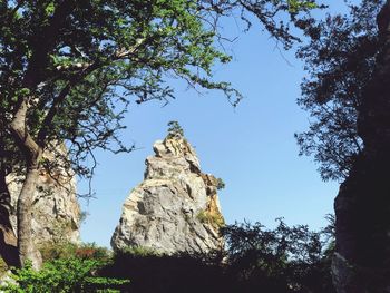 Low angle view of rock formation against sky