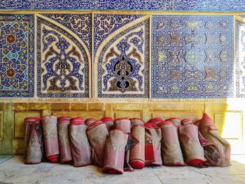Full frame shot of multi colored umbrellas on tiled floor against wall of building