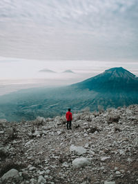 Rear view of man on sindoro mountain in the morning