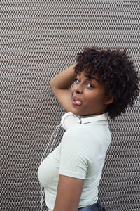 Portrait of a girl with afro hair with cheerful attitude in the urban background. 