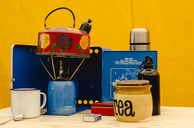 Close-up of telephone booth on table against wall