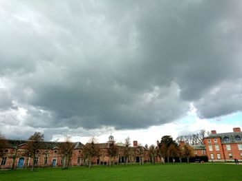 Buildings against cloudy sky