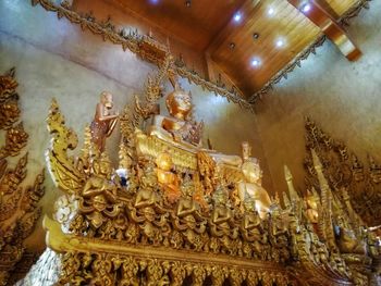 Low angle view of illuminated statue in temple