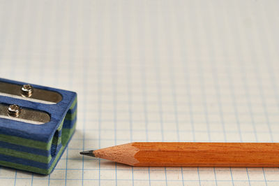 Close-up of pencil by sharpener on paper