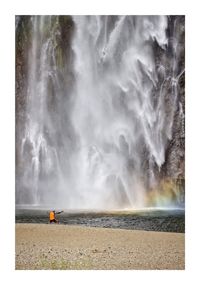 Rear view of man surfing in sea