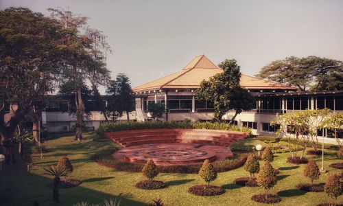 Lawn in front of building against clear sky