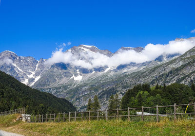 Scenic view of snowcapped mountains against blue sky