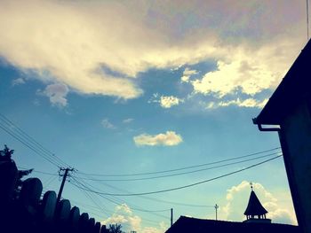 Low angle view of building against cloudy sky