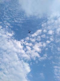 Low angle view of airplane flying in sky