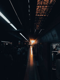 Rear view of people walking in subway