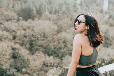 Smiling young woman wearing eyeglasses outdoors